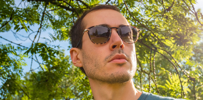 Man wearing polarised sunglasses outdoors in bright natural light