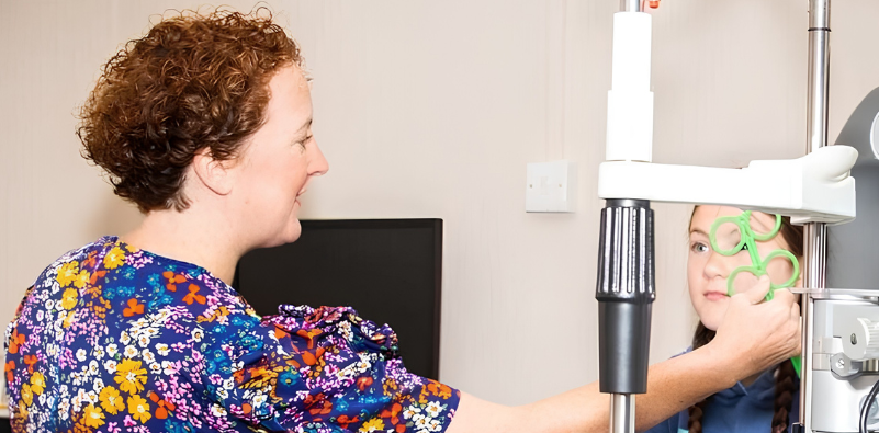 Sandie, an optometrist at Simpson Optometrists, checking a child’s eyes during an eye examination