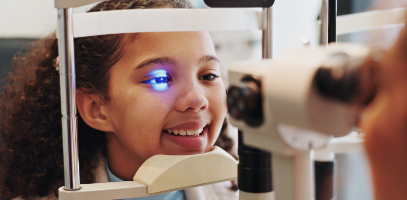 Child having an eye examination with an optometrist to check their vision and eye health